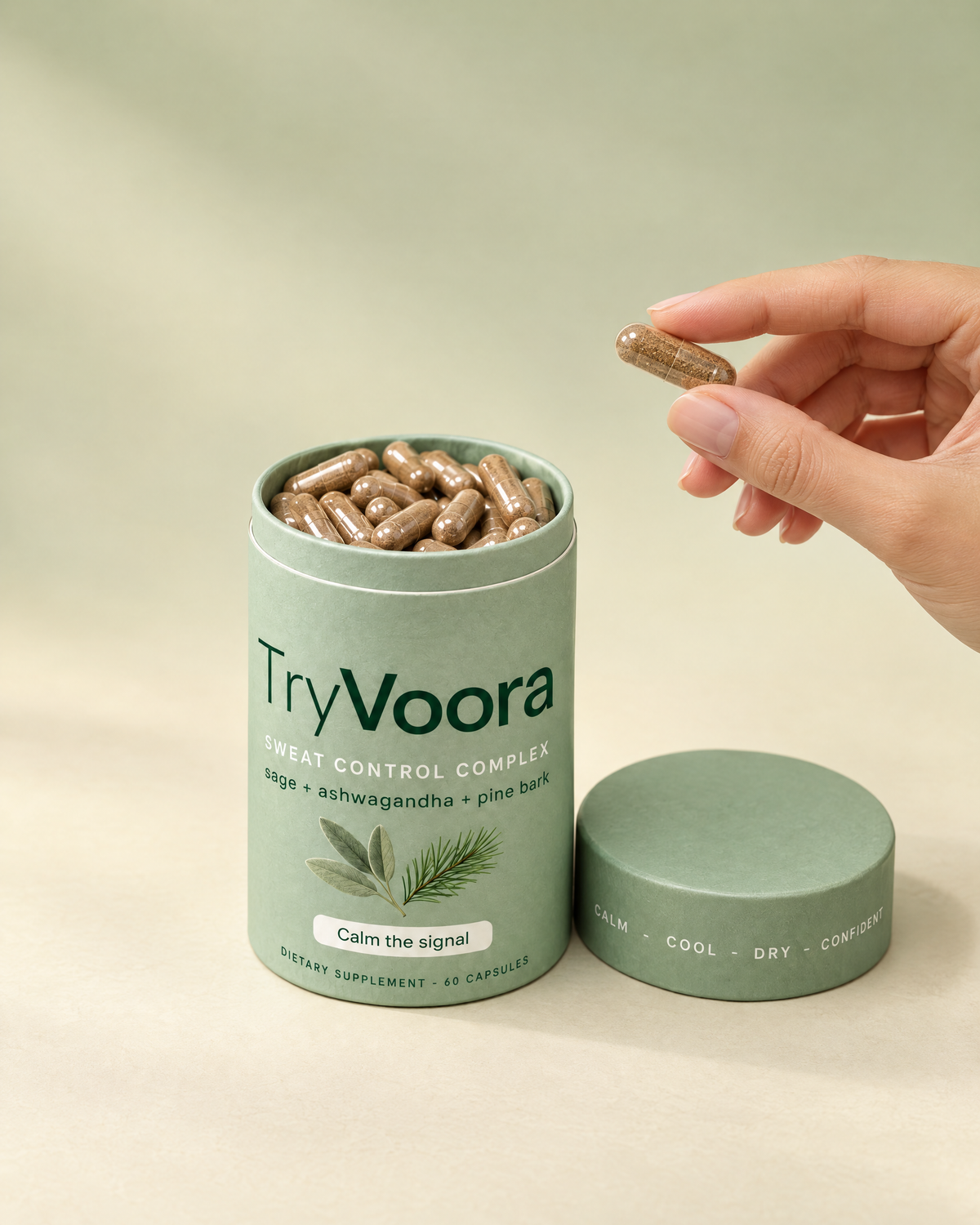 Voora capsule held next to the open canister